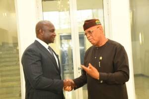 Dr Samuel Obuku shaking hands with Gov Umoh Eno Akwa Ibom State Governor